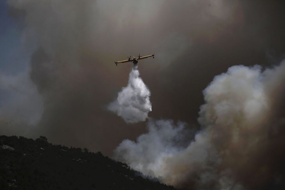 Wildfires lead to evacuations in Greece  / KOSTAS TSIRONIS