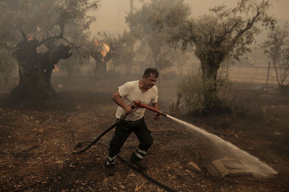 Wildfires lead to evacuations in Greece  / KOSTAS TSIRONIS